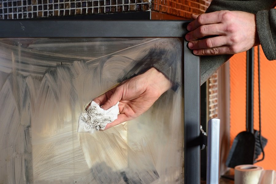cleaning fireplace glass with newspapers